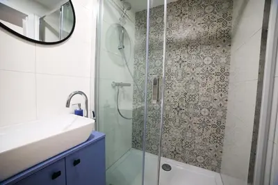 a bathroom with a shower and a sink at CracWoW Saint Sebastian Apartments in Kraków