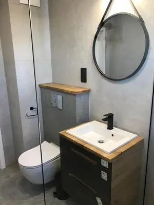 a bathroom with a toilet and a sink and a mirror at Pszczelna Loft in Kraków