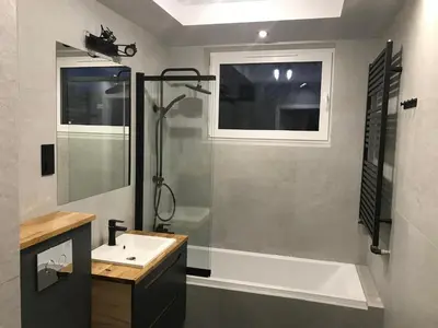 a bathroom with a tub and a sink and a shower at Pszczelna Loft in Kraków
