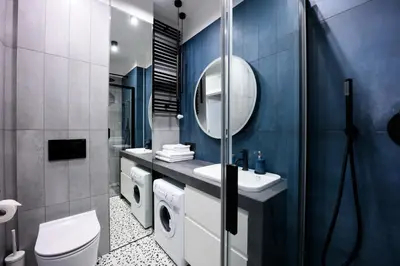 a bathroom with a toilet sink and a mirror at Native Apartments Barska 69 in Kraków