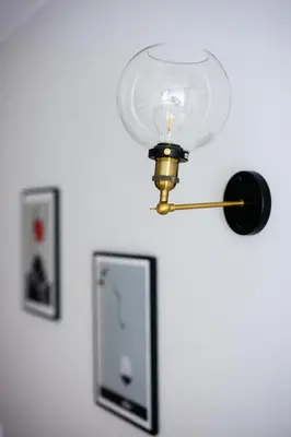 a light attached to a wall with a mirror at Native Apartments Barska 69 in Kraków