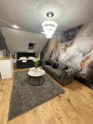 a living room with a couch and a table at MAŁY KSIĄŻĘ in Podzamcze