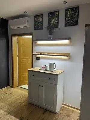 a kitchen with a counter with a sink and a door at MAŁY KSIĄŻĘ in Podzamcze