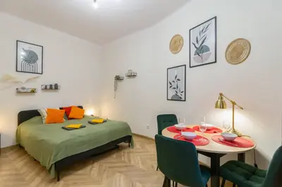 a bedroom with a bed and a table and chairs at Paulinska20-Kaziermierz-2 Rooms in Kraków