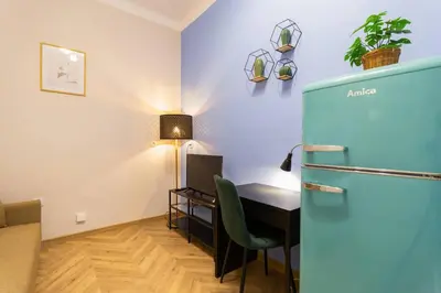 a room with a desk and a table with a chair at Paulinska20-Kaziermierz-2 Rooms in Kraków