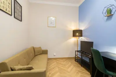 a living room with a couch and a television at Paulinska20-Kaziermierz-2 Rooms in Kraków