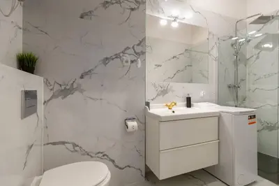 a bathroom with a toilet and a sink and a shower at Paulinska20-Kaziermierz-2 Rooms in Kraków