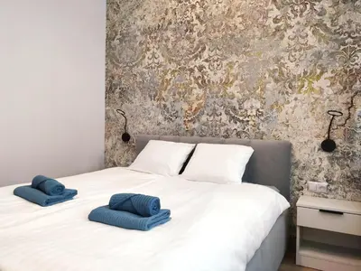 a bedroom with a bed with two blue pillows on it at Celna 7 by Homeprime in Kraków