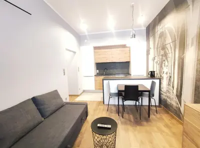 a living room with a couch and a table at Celna 7 by Homeprime in Kraków