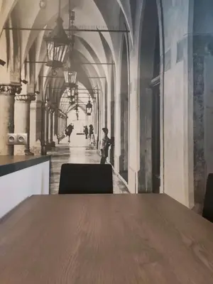 a table in a room with a painting of a hallway at Celna 7 by Homeprime in Kraków