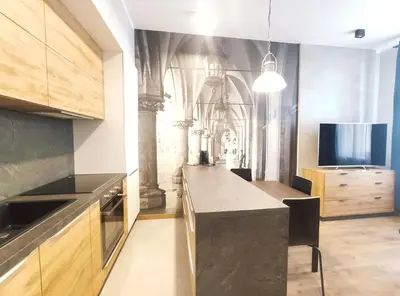 a kitchen with a counter top and a tv at Celna 7 by Homeprime in Kraków