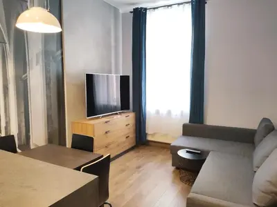 a living room with a couch and a television at Celna 7 by Homeprime in Kraków