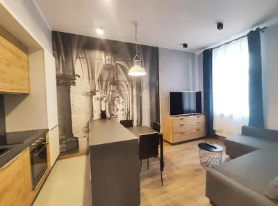 a living room with a kitchen with a table and a tv at Celna 7 by Homeprime in Kraków