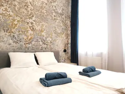 a bed with two blue pillows on top of it at Celna 7 by Homeprime in Kraków