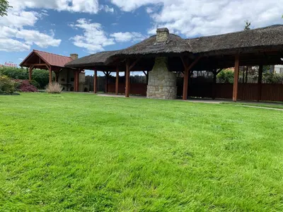a pavilion with a grass field in front of it at Hotel August in Brzesko