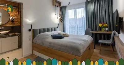 a bedroom with a bed and a desk and a table at mN apartments home - Wieliczka Town in Wieliczka