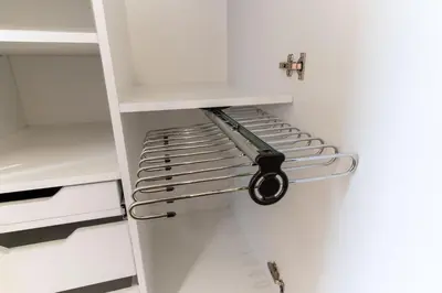a white closet with a metal shelf in it at mN apartments home - Wieliczka Town in Wieliczka