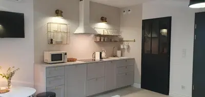 a kitchen with white cabinets and a microwave at Fly_to_Cracow_12 in Kraków