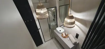 a bathroom with a sink and two chandeliers at Fly_to_Cracow_12 in Kraków