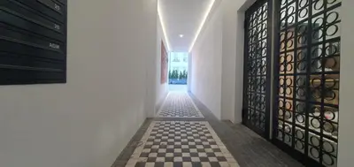 a hallway with a checkered floor and black doors at Fly_to_Cracow_12 in Kraków