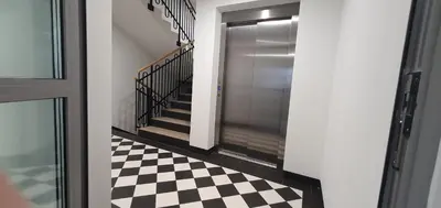 a hallway with a black and white checkered floor at Fly_to_Cracow_12 in Kraków