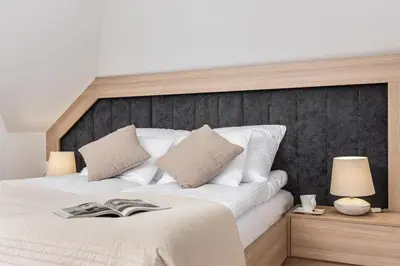 a bedroom with a large white bed with two lamps at Ucieknij do luksusu: Villa Wola in Kraków