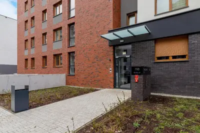 a brick building with a parking meter in front of it at Lux Apartment Grzegórzecka Estate Cracow by Renters Prestige in Kraków