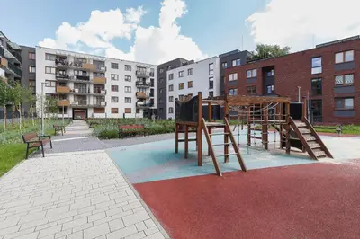a park with a playground with benches and buildings at Lux Apartment Grzegórzecka Estate Cracow by Renters Prestige in Kraków