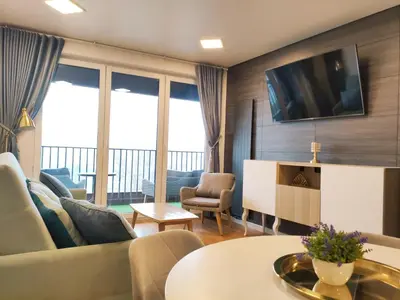 a living room with a couch and a tv at Zabłocie 35 by Homeprime in Kraków
