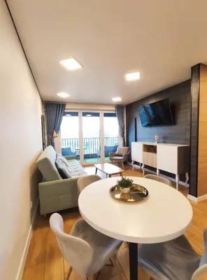 a living room with a table and a couch at Zabłocie 35 by Homeprime in Kraków