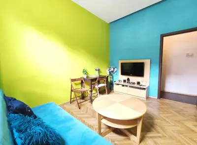 a living room with a blue couch and a table at Józefa 2 by Homeprime in Kraków