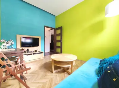 a living room with green and blue walls at Józefa 2 by Homeprime in Kraków
