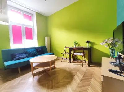 a living room with a blue couch and a table at Józefa 2 by Homeprime in Kraków