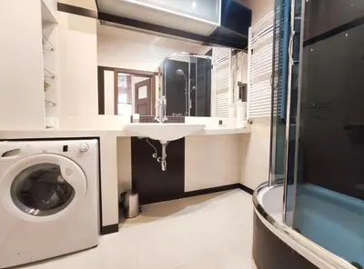 a bathroom with a washing machine and a sink at Józefa 2 by Homeprime in Kraków