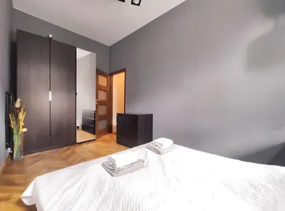 a bedroom with a white bed and a mirror at Józefa 2 by Homeprime in Kraków