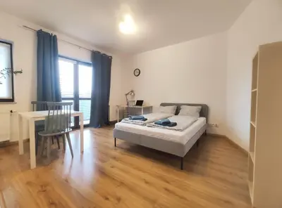 a bedroom with a bed and a table and a desk at Śliczna 34A by Homeprime in Kraków