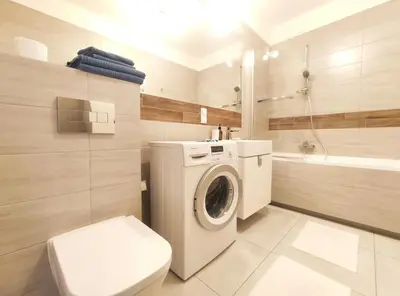 a bathroom with a washing machine and a toilet at Śliczna 34A by Homeprime in Kraków