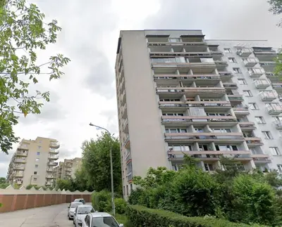 a tall building with cars parked in front of it at Śliczna 34A by Homeprime in Kraków