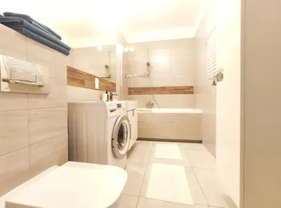 a bathroom with a washing machine and a toilet at Śliczna 34A by Homeprime in Kraków