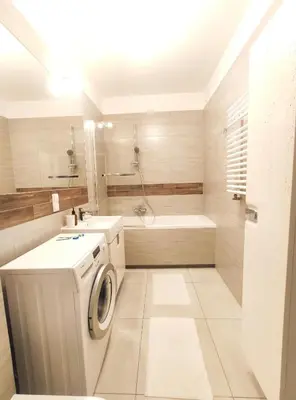 a bathroom with a washing machine and a bath tub at Śliczna 34A by Homeprime in Kraków