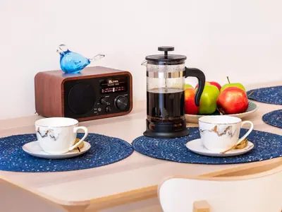 two cups of coffee on a table next to a toaster at TRUE COLORS Old Town Apartments - Wawel & Vistula River - Homelike Kraków in Kraków