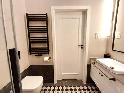 a bathroom with a white toilet and a sink at TRUE COLORS Old Town Apartments - Wawel & Vistula River - Homelike Kraków in Kraków
