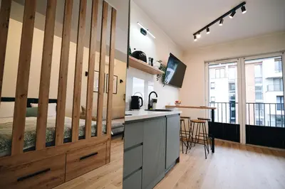 a kitchen with a large wooden sliding barn door at ZatoRest 43 by Housine in Zator