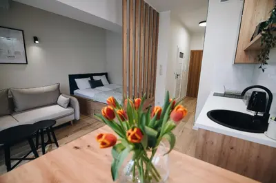 a living room with a couch and a table with flowers at ZatoRest 43 by Housine in Zator