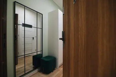 a room with a glass door and a green stool at ZatoRest 43 by Housine in Zator