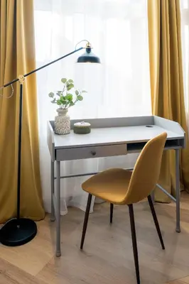 a desk with a lamp and a yellow chair at WAWELOVE Piłsudskiego - 3 bedroom apt. with balcony and free parking! in Kraków