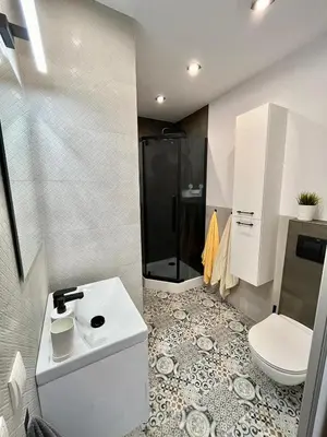 a bathroom with a toilet and a sink and a shower at Mała Góra Apartment in Kraków