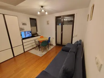 a living room with a couch and a table at Mała Góra Apartment in Kraków