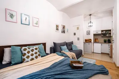 a bedroom with a bed and a couch at St. Miasto Studio Kraków in Kraków