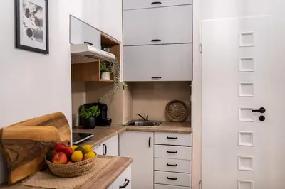 a kitchen with a bowl of fruit on a counter at St. Miasto Studio Kraków in Kraków